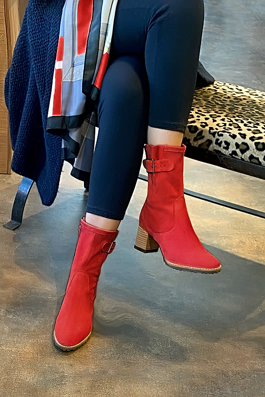 Scarlet red women's ankle boots with buckles on the sides. Round toe. Medium block heels. Worn view - Florence KOOIJMAN
